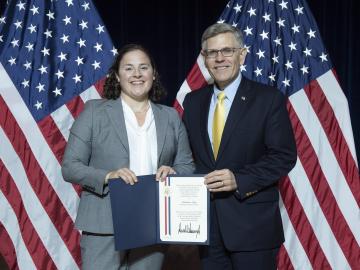 ORNL’s Kate Page, left, received a PECASE citation from Kelvin Droegemeier, Director of White House Office of Science and Technology Policy. Credit: Donica Payne/U.S. Dept. of Energy