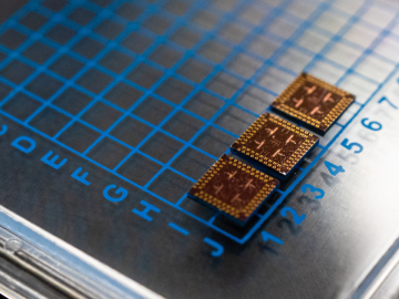 ORNL-developed cryogenic memory cell circuit designs fabricated onto these small chips by SeeQC, a superconducting technology company, successfully demonstrated read, write and reset memory functions. Credit: Carlos Jones/Oak Ridge National Laboratory, U.S. Dept. of Energy  