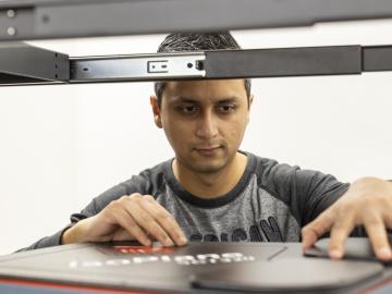 Postdoctoral researcher Nischal Kafle positions a component for a portable plasma imaging diagnostic device at ORNL in February. The device, a project for ARPA-E, is built of off-the-shelf parts. Credit: Carlos Jones/ORNL