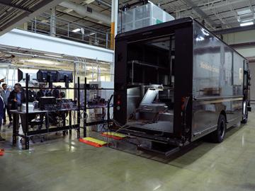 Oak Ridge National Laboratory researchers demonstrated on Feb. 27 a 20-kilowatt, bi-directional wireless charging system on a medium-class hybrid electric delivery truck. Credit: Brittany Cramer/Oak Ridge National Laboratory, U.S. Dept. of Energy