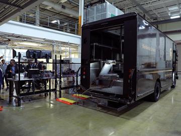 Oak Ridge National Laboratory researchers demonstrated on Feb. 27 a 20-kilowatt, bi-directional wireless charging system on a medium-class hybrid electric delivery truck. Credit: Brittany Cramer/Oak Ridge National Laboratory, U.S. Dept. of Energy