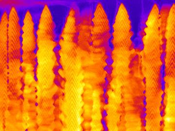 A nanobrush made by pulsed laser deposition of CeO2 and Y2O3 with dim and bright bands, respectively, is seen in cross-section with scanning transmission electron microscopy. Credit: Oak Ridge National Laboratory, U.S. Dept. of Energy