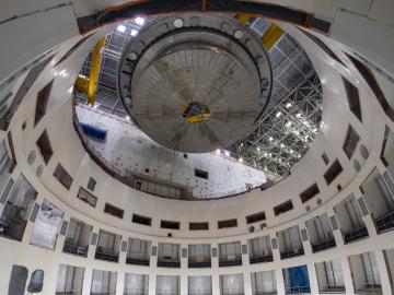 The 1250 ton cyrostat base is positioned over the ITER tokamak pit for installation. This base is the heaviest lift of tokamak assembly. Credit: ITER Organization