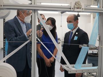 U.S. Department of Energy Deputy Secretary Mark Menezes (right) tours the DemeTECH N95 filter material production area with Xin Sun, ORNL interim associate laboratory director (center) and Craig Blue, ORNL advanced manufacturing program manager. Credit: US Dept. of Energy