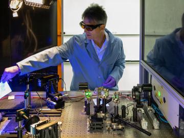 ORNL scientist Adrian Sabau describes components of a laser-interference structuring system that was used to treat aluminum alloy sheets for corrosion protection. Credit: Carlos Jones/ORNL, U.S. Dept. of Energy