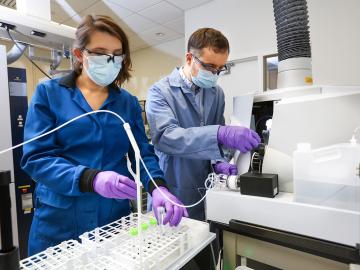 Santa Jansone-Popova, left, and Ilja Popovs quantify rare-earth element concentrations in liquid samples using a spectroscopy instrument. Credit: Genevieve Martin/ORNL, U.S. Dept. of Energy 