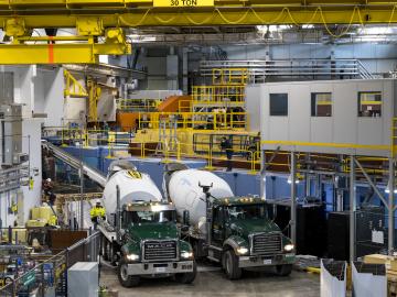 Trucks deliver concrete to the VENUS instrument construction site at the Spallation Neutron Source. Credit: ORNL/Carlos Jones