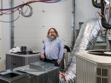 Brian Fricke, equipment research group lead at ORNL, works with Anthony Gehl at the Building Technologies Research and Integration Center on a new prototype installation. Collaboration with fellow researchers across the building technologies area strengthens his group’s capabilities. Credit: ORNL, U.S. Dept. of Energy