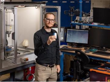 Logan Sturm, Alvin M. Weinberg Fellow at ORNL, creates a mashup between additive manufacturing and cybersecurity research. Credit: Carlos Jones/ORNL, U.S. Dept. of Energy 