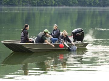 ORNL researchers deploy a gas trap to measure ebullitive (bubbling) emissions of methane at the Melton Dam in East Tennessee. The trap is deployed for ~ 24 hours to allow gas to accumulate in the trap. Credit: Carlos Jones/ORNL, US Dept. of Energy