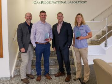 From left, Craig Moss, Major Micah McCracken, Tim Delk and Lt. Col. Jessica Critcher pose with awards given at a small ceremony recognizing ORNL’s 2022 military fellows. Credit: Genevieve Martin/ORNL, U.S. Dept. of Energy