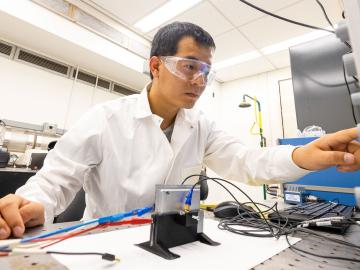 Researcher Sun Hongbin examines material changes to a battery made in the DOE’s Battery Manufacturing Facility using an ultrasound sensor. Credit: Carlos Jones/ORNL, U.S. Dept. of Energy