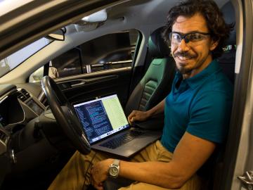 Bobby Bridges sits in the driver's seat of a car