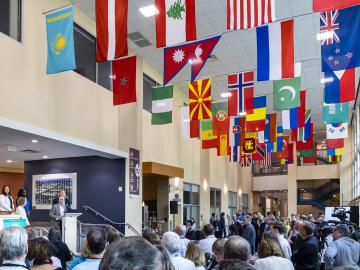 Oak Ridge National Laboratory staff and visitors gathered on “Main Street” to dedicate a renovated International Hall of flag and unveil new displays reflecting the lab’s rich 80-year history. Credit: Carlos Jones/ORNL, U.S. Dept. of Energy