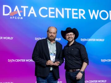 Data Center World keynote presenter, Bill Kleyman, right, presented ORNL’s Paul Abston with the Data Center Manager of the Year 2023 award during the conference’s general session on May 9. Credit: Data Center World AFCOM