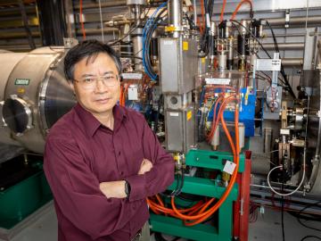 ORNL’s Yun Liu stands before one of the 10 laser comb-based beam diagnostics stations at the Spallation Neutron Source. The laser comb solves the longstanding problem of measuring changes in the beam across time. Credit: Genevieve Martin/ORNL, U.S. Dept. of Energy