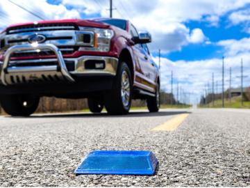 ORNL researchers have enabled standard raised pavement markers to transmit GPS information that helps autonomous driving features function better in remote areas or in bad weather. Credit: Carlos Jones/ORNL, U.S. Dept. of Energy