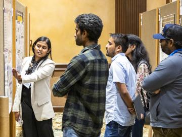 Chathuddasie Amarasinghe explains her research poster, “Using Microfluidic Mother Machine Devices to Study the Correlated Dynamics of Ribosomes and Chromosomes in Escherichia Coli.” Credit: Carlos Jones/ORNL, U.S. Dept. of Energy