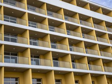 Side of building showing windows and balconies.