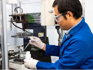 ORNL researcher Zhijia Du inserts a newly developed liquid electrolyte material into a battery pouch cell. The formulation extends the life of extreme-fast-charging batteries like those used in electric vehicles. Credit: Genevieve Martin/ORNL, U.S. Dept. of Energy