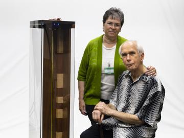 ORNL retiree Duane Starr and his wife, Nancy, pose with the critical frequencies demo unit Duane designed, built and donated to the laboratory to support nuclear workshops.  Credit: Carlos Jones/ORNL, Dept. of Energy