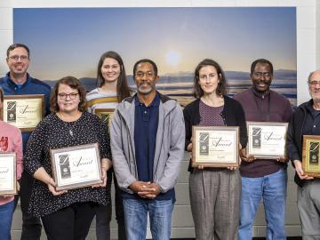 Environmental Sciences Division Director Eric Pierce presented the organization’s 2023 Distinguished Achievement awards at a December 7 all-hands meeting. From left: Megan Johnson, Michael Jones, Maria Colberg, Rachel Pilla, Eric Pierce, Rocio Uria-Martinez, Gbadebo Oladosu and Paul Leiby. Credit: Carlos Jones/ORNL, U.S. Dept. of Energy