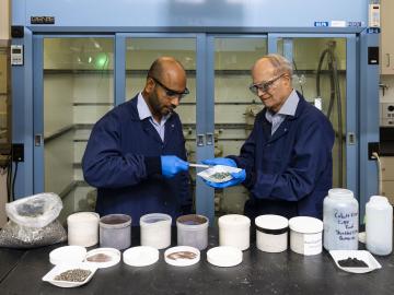 From left, researchers Syed Islam and Ramesh Bhave discuss the nickel sulfate recovered from end-of-life lithium-ion batteries using the membrane solvent extraction process they co-invented at ORNL. Credit: Carlos Jones/ORNL, U.S. Dept. of Energy