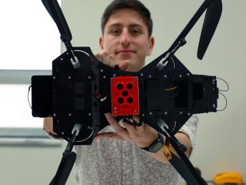 ORNL intern Jack Orebaugh holds the drone used in his research to help locate human remains. Credit: Lena Shoemaker/ORNL, U.S. Dept. of Energy