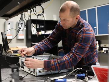 ORNL researcher Brian Williams prepares for a demonstration of a quantum key distribution system. Credit: Genevieve Martin/ORNL, U.S. Dept. of Energy