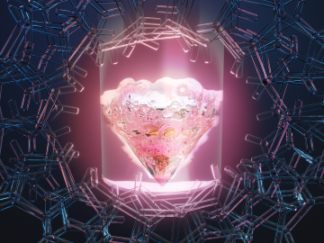 Photo of glowing, pink diamond-shaped figure. This is illuminated with light, encircled with a wreath of around 70 blue tube-like shapes. 