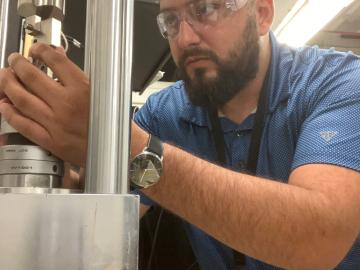 A technician in the Advanced Nuclear Materials Group works in the lab.