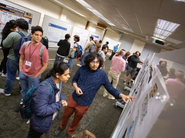 Students gather at a poster session