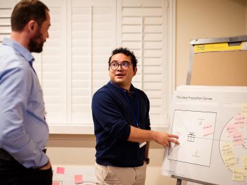 Dmytro Bykov, left, and Hector Corzo participate in a value proposition development exercise as part Energy I-Corps