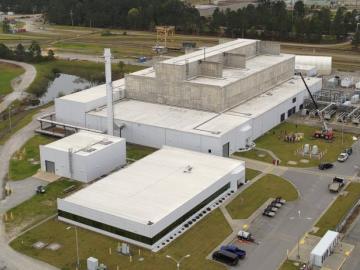 Ariel view of the Salt Waste Processing Facility, which is big, white and square. 