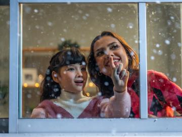 Child by window while snowing (Envato Elements)