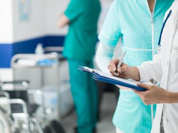 Doctor holding medical records (Envato Elements)