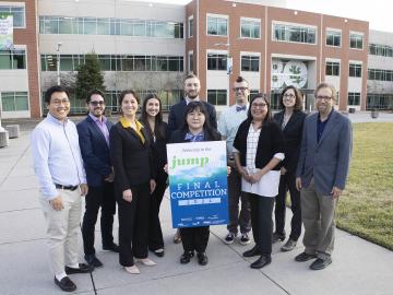 10 members of JUMP into STEM leadership are standing on the ORNL quad posting with the poster
