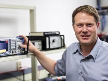 Corey Cooke is pictured standing next to radar technology