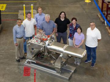 Members of the target design team pose next to the 2.0-megawatt-capable mercury flow target they developed. 