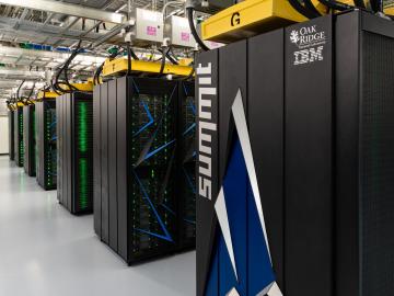 The summit supercomputer logo on a computer cabinet off center going to the left. There are 7 cabinets going off to the left. 