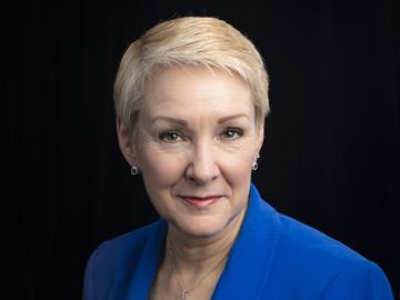 Kathryn McCarthy, director of the US ITER Project is pictured here posing against a black background. 