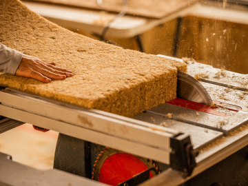HempWool, Hempitecture’s hemp fiber batt insulation is being cut here
