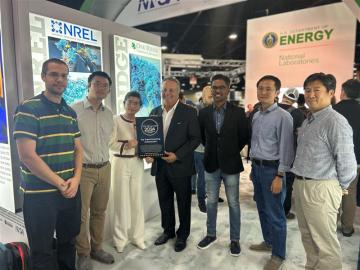 7 people from ORBIT research team accept their award from Tom Tabor (middle)