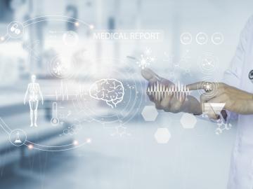 Stock image of a person in a doctor's coat pointing to white graphics if a person, world and dots, symbolizing the artificial intelligence technology used for cancer pathology
