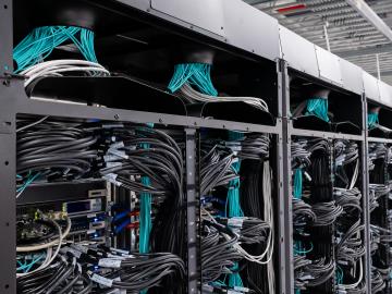 Wall of black computer chords with blue wiring