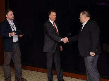 Dr. Dimitri Kusnezov (center), assisted by Edmon Begoli (left), thanks Kris Torgerson, ORNL chief information and privacy officer, for ITSD’s efforts on the MVP-CHAMPION program.
