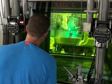 ORNL and EPRI built an enclosed welding system in a hot cell of ORNL’s Radiochemical Engineering Development Center. C. Scott White (ORNL) performs operations with remotely controlled manipulators and cameras. 