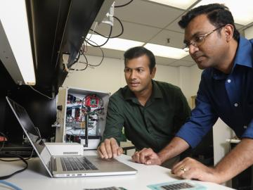 ORNL researchers Gautam Thakur (left) and Teja Kuruganti demonstrate UrbanSense, a novel sensor network aimed at helping cities manage their growth and evaluate future development opportunities. The platform collects open-source population, traffic and en ORNL researchers Gautam Thakur (left) and Teja Kuruganti demonstrate UrbanSense, a novel sensor network aimed at helping cities manage their growth and evaluate future development opportunities. The platform collects open-source population, traffic and en