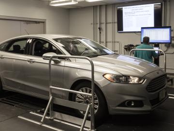 ORNL’s Frank Combs and Michael Starr of the U.S. Armed Forces (driver) work in ORNL’s Vehicle Security Laboratory to evaluate a prototype device that can detect network intrusions in all modern vehicles. Credit: Carlos Jones/ORNL, U.S. Dept. of Energy