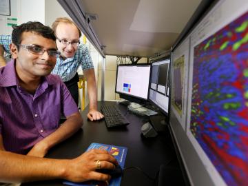 ORNL’s Sergei Kalinin and Rama Vasudevan (far left) used scanning probe microscopy to discover inseparable interplay between bulk ferroelectricity and surface electrochemistry in a 30-nanometer-thick film of barium titanate. ORNL’s Sergei Kalinin and Rama Vasudevan (far left) used scanning probe microscopy to discover inseparable interplay between bulk ferroelectricity and surface electrochemistry in a 30-nanometer-thick film of barium titanate.